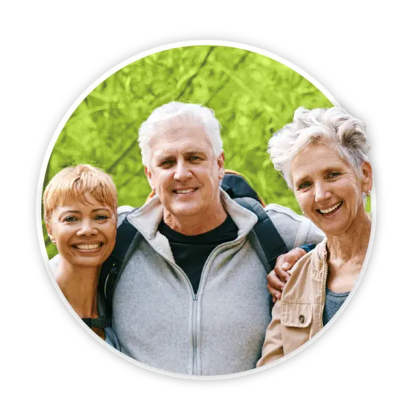 Three adults stood outdoors smiling